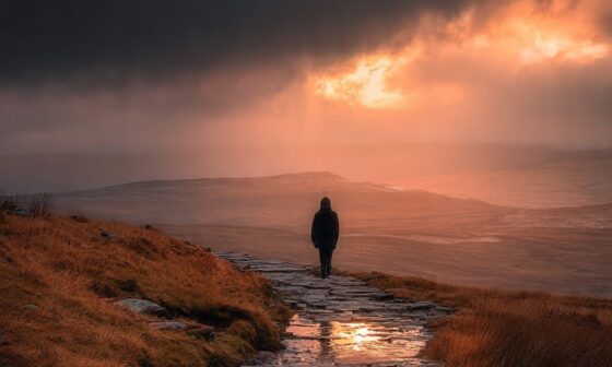 A solitary person walking toward the sunrise on a rugged path, representing moral courage, integrity, and the strength to choose truth over approval.