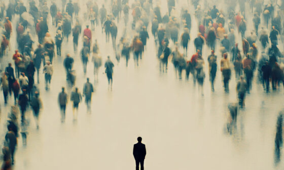 A single individual standing apart from a crowd moving together, representing resistance to conformity and the courage to think independently.