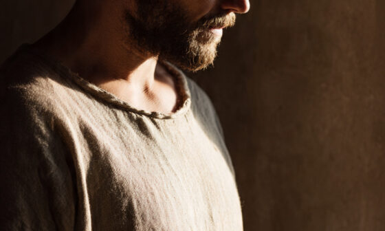 A person holding an open Bible in soft light, symbolizing ministry rooted in mercy, endurance, and truth lived openly before God and others