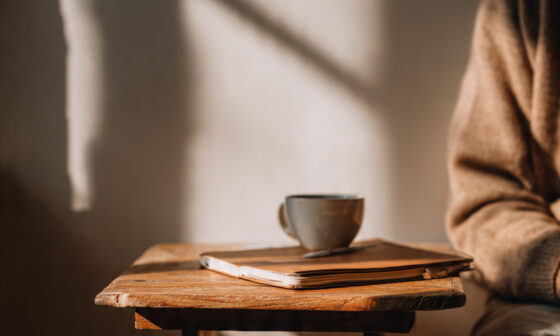 A person quietly reflecting at a desk, symbolizing private growth, authenticity, and freedom from the need to impress others.