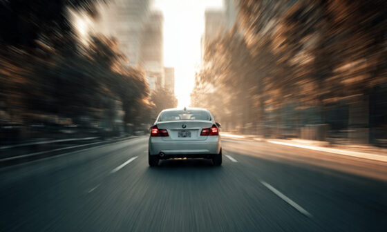 Image of a car driving away from a blurry background: "Symbol of moving forward from past trauma and accidents."