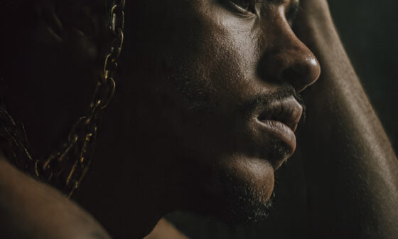 A person reflecting deeply while breaking free from negative thoughts, representing taking every thought captive in 2 Corinthians 10:5