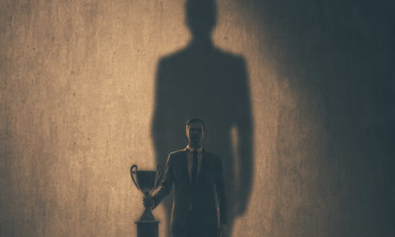 person carrying a heavy burden symbolizing responsibility after success