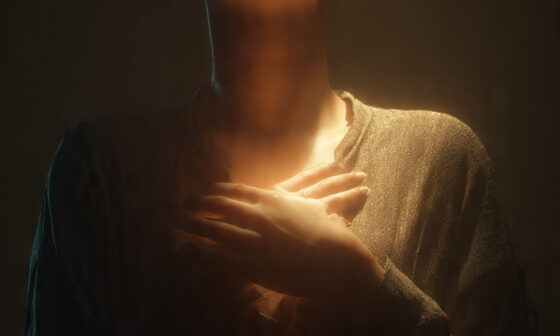 A person reflecting in a quiet moment with light symbolizing love, representing the meaning of 1 Corinthians 13 that without love we are nothing