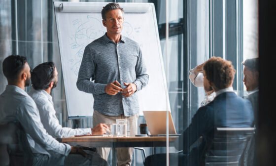 An image of a man training other men in a corporate settings