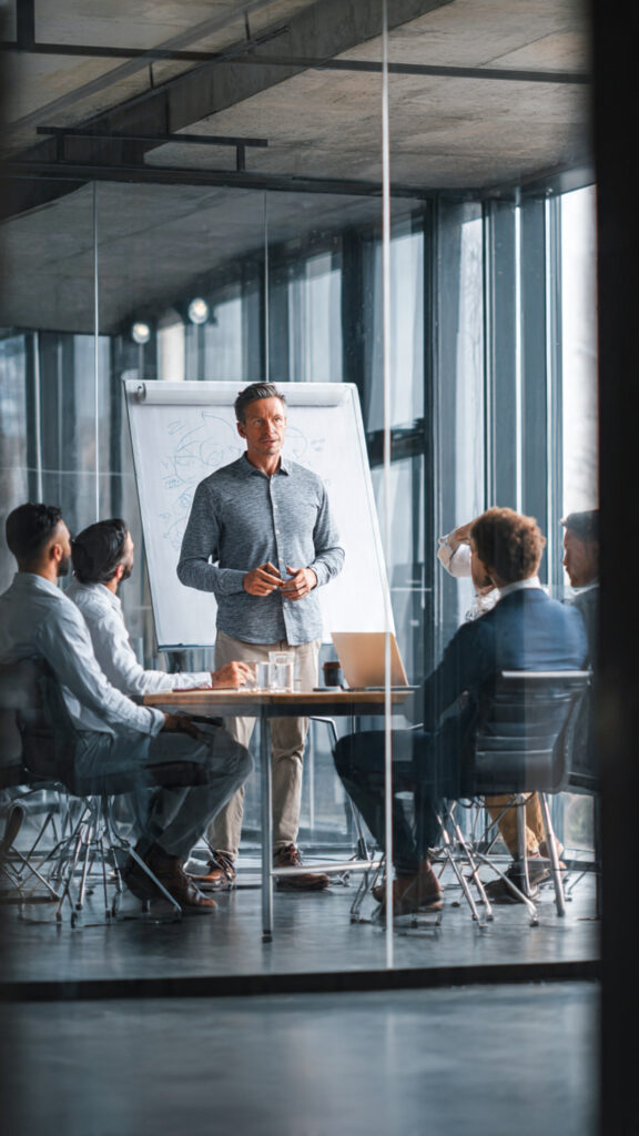 An image of a man training other men in a corporate settings