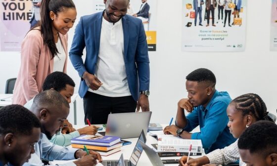 Students and mentors gather in a HENOSIS learning environment focused on education and personal development.